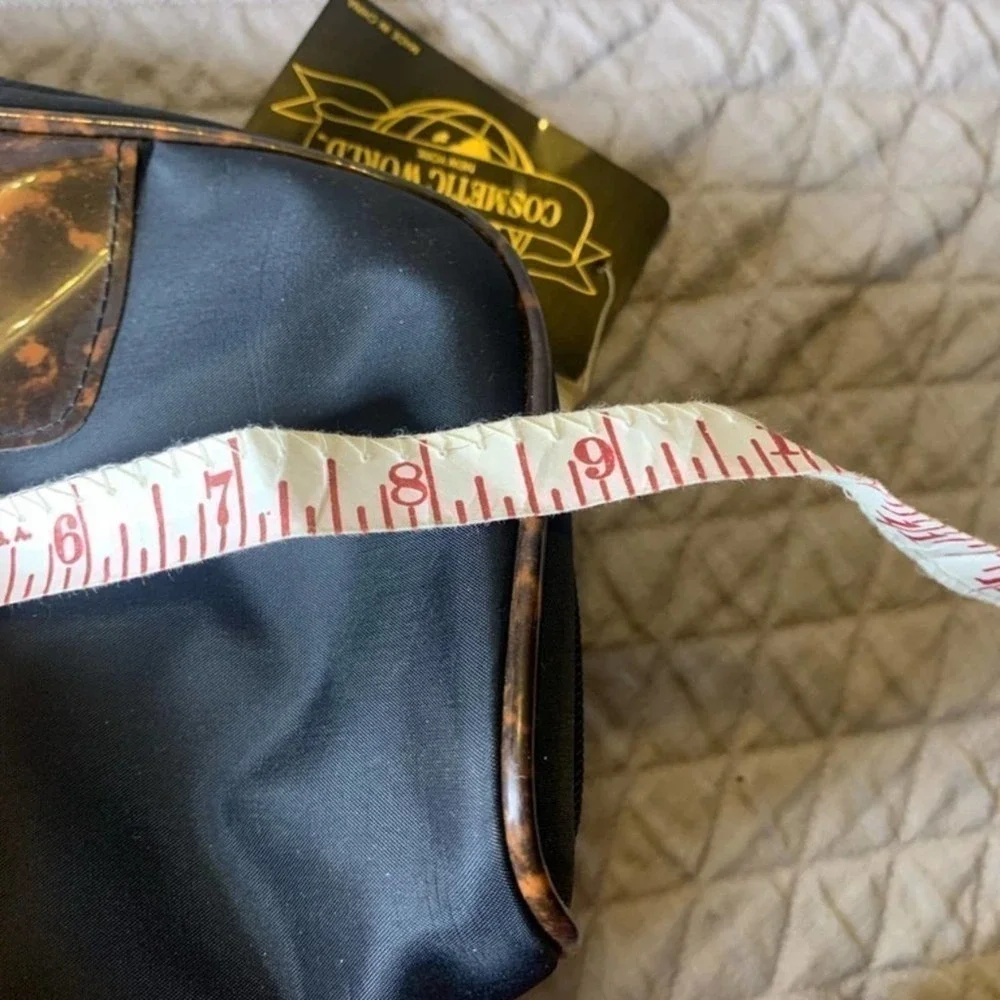 𝅺5/ $25 Cosmetic World black makeup bag with animal print
